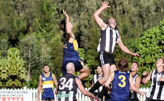 Byron ruckman Karim Kaufman taps down to teammate Nathan Moon during the South-East Queensland AFL Division 4 preliminary final against Bond University on Saturday. Byron ruckman Karim Kaufman taps down to teammate Nathan Moon during the South-East Queensland AFL Division 4 preliminary final against Bond University on Saturday.